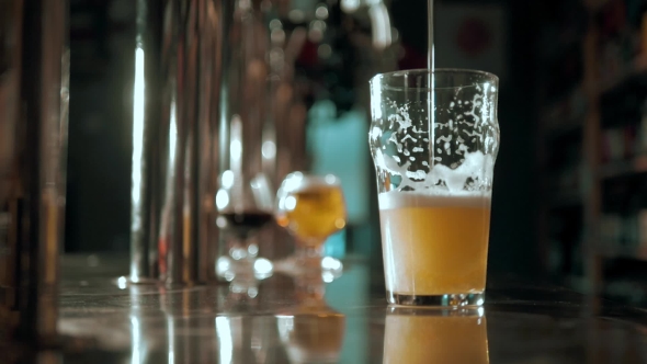 Beer Into Glass With a Lot Of Bubles And Foam Super  . alt