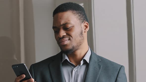 Frustrated African American Guy Look at Cell Phone Screen Reads Bad News in Mobile Message Concept alt