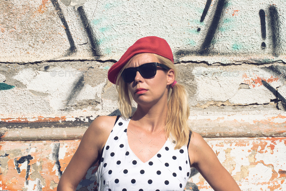 Portrait of blonde woman with polka dress and red hat - Stock Photo - Images