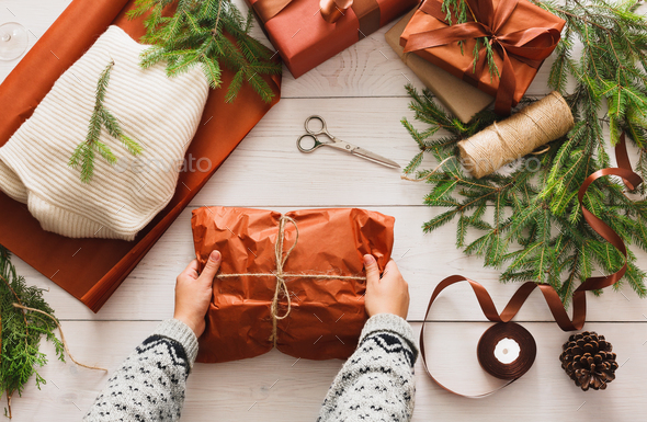 Wrapping christmas present gift on white wood background - Stock Photo - Images