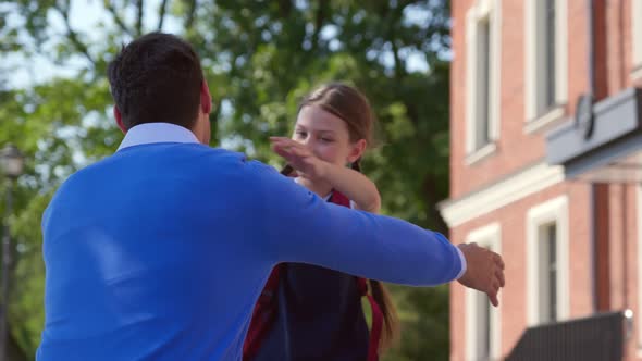 Schoolgirl After School Running to Father and Hugging Outdoors alt