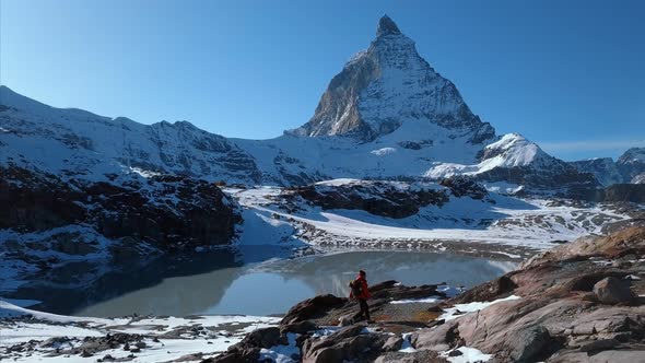 Hipster Hiker Walks on Mountain Ridge in Winter