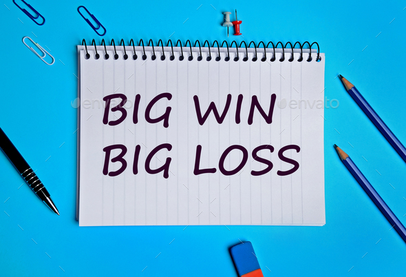 Big win Big loss words on notebook