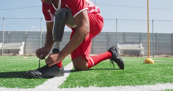 Soccer player with prosthetic leg on field alt