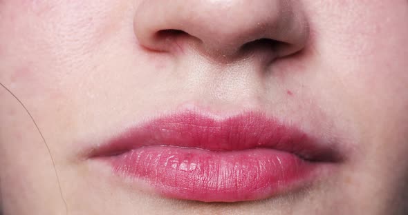 Woman's Lips Kissing in Close-up.