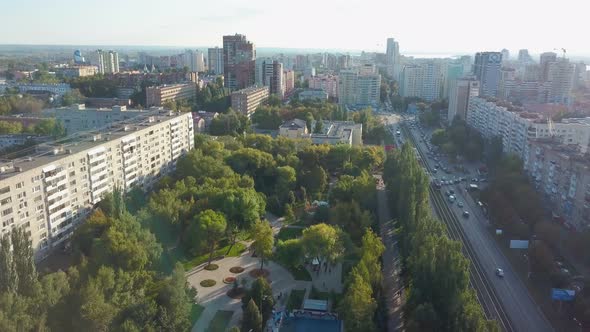 Aerial Panorama of Calm Modern City in Sunny Evening in Summer, Lowering To Park Area