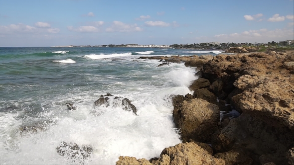 Waves Breaking Against Rocks On Sea Shoreline.