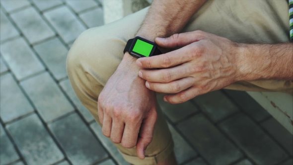 Man Hands Use Modern Smart Watch With a Green Screen Chroma Key alt
