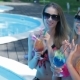 Two Women Drink Cocktails On The Swimming Poolside - VideoHive Item for Sale