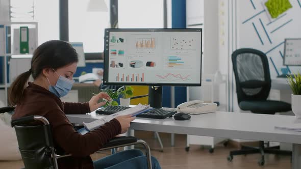 Employee with Disabilities Working for Deadline Project Wearing Face Mask alt