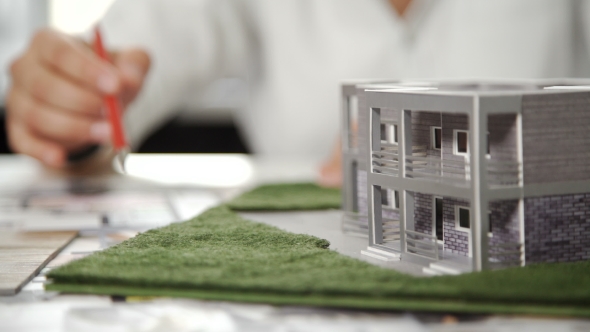 Engineer Work On Table With Architecture Model And White Helmet. . alt