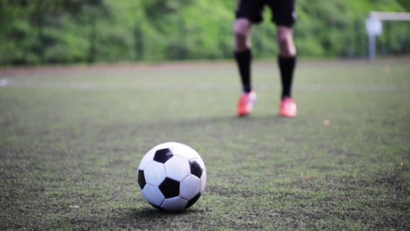 Football Player Playing With Ball On Field by dolgachov | VideoHive