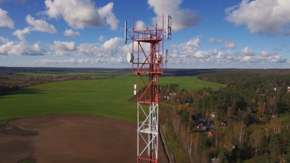 Aerial view of a telecommunication cell phone tower standing in the field