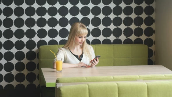 Girl Texting Sms Using Mobile Phone In Cafe