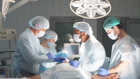 Medical Team Performing Surgical Operation in Bright Modern Operating Room alt