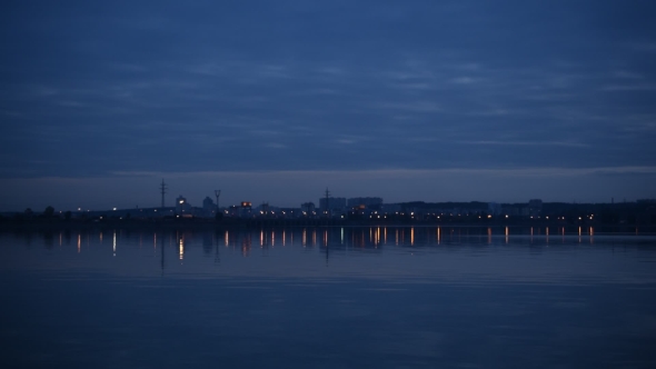 City Lights Reflected In Water In The Evening