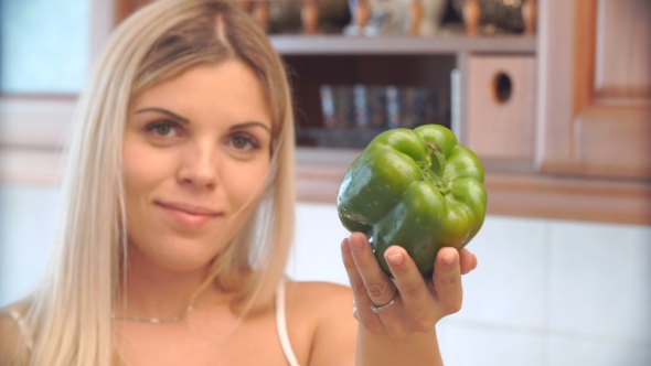 Blonde Woman Holding a Pepper, Focus On Pepper.