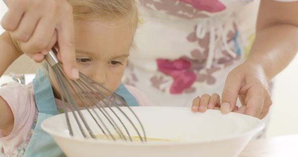 Little Girl Baking With Her Mother alt