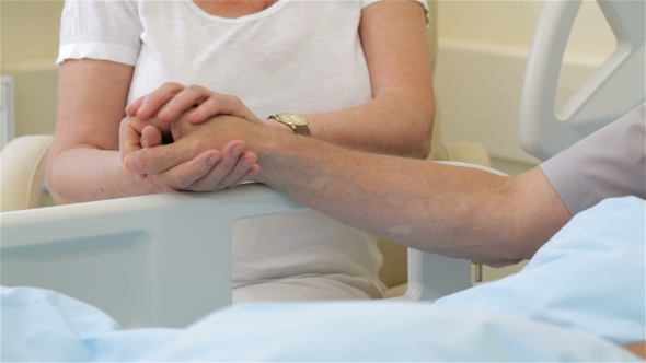 Senior Ill Man Put His Hand On His Wife's Palm alt