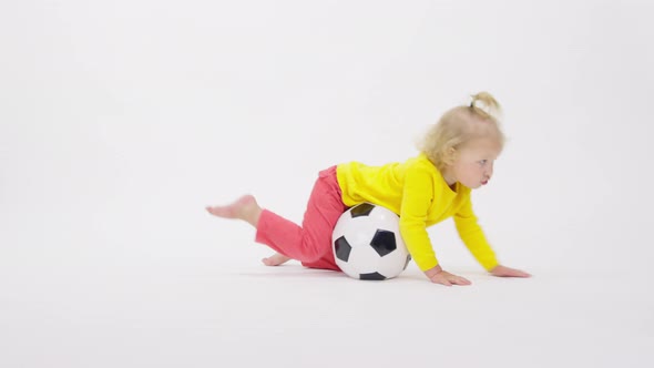 Adorable Happy Cheerful Toddler Girl Playing with Soccer Ball Isolated on White