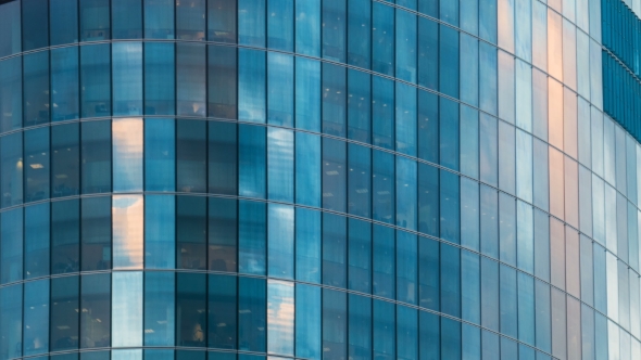 Office Building Skyscraper in the Windows of which reflected the passing clouds alt