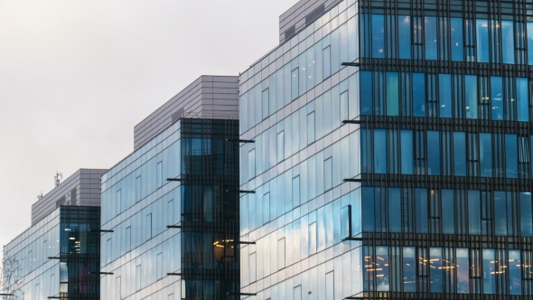 Office Building Skyscraper in the Windows of which reflected the passing clouds alt
