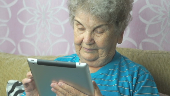 Aged Woman Using a Computer Tablet
