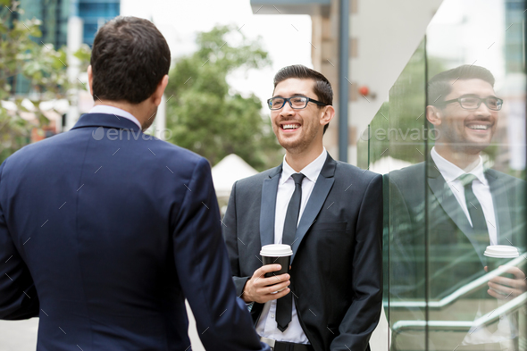 Two businessmen talking outdoors - Stock Photo - Images