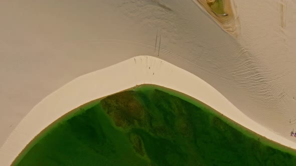 H264drone Soaring Showing The Nuance Of Green Colors Inside The Pond. Dune Around