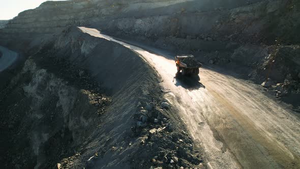 Mining truck is driving an opencast quarry. Quarry Dump Truck. alt