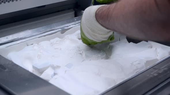 A Man Working with a Working Vacuum Cleaner to Clean White Powder of Polyamide alt