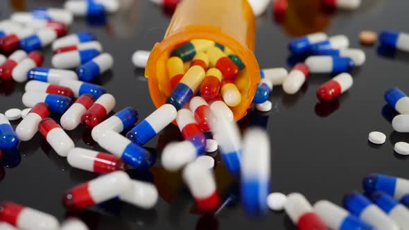 Many prescription pills, drugs and antibiotics falling in slow motion on an orange pharmacy medicine alt