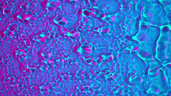 Super Slow Motion Abstract Shot of Swirling Neon Water at 1000Fps. alt