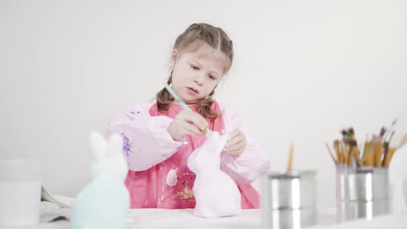 Little Girl Painting Paper Mache Figurine at Homeschooling Art Class alt