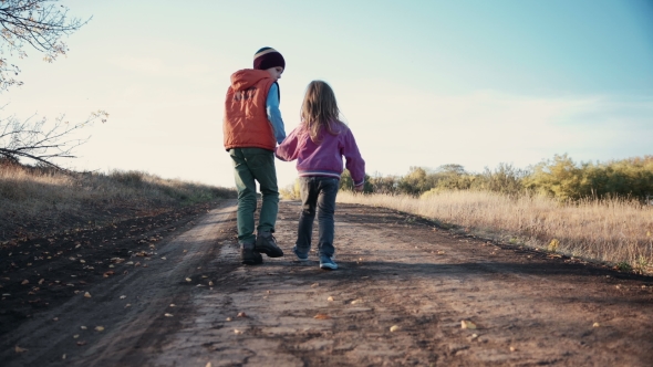 Two Young Children Walking Along a Dirt Road, Stock Footage | VideoHive