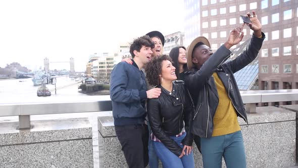 Multiracial group of friends taking a selfie together in London alt