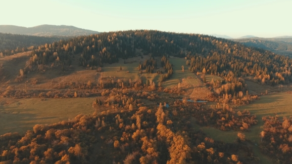 Aerial Shot Of a Hilly And Mountainous Terrain. Landscape At Sunset.