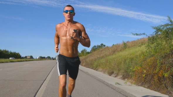 Handsome Man Jogging On River Bank