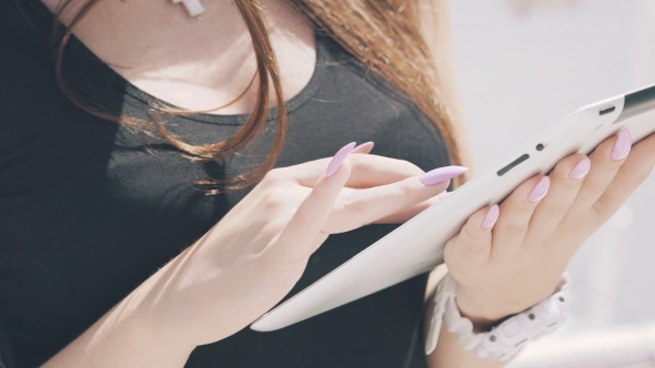 Female's Hands Using Tablet On Black T-shirt Background alt