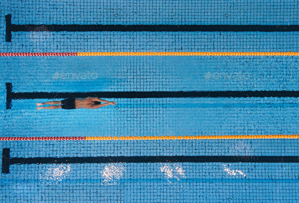 Male swimmer swimming laps in a pool
