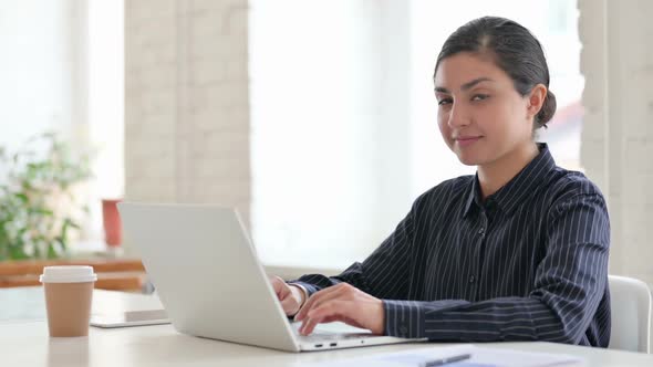 Cheerful Young Indian Woman with Laptop Smiling at Camera alt