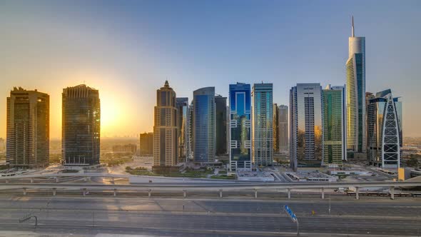 Aerial View of Jumeirah Lakes Towers Skyscrapers at Sunrise Timelapse with Traffic on Sheikh Zayed alt