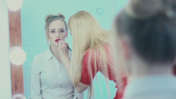 The Reflection In The Mirror Make-up Work. Makeup Artist Paints Lips