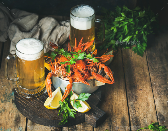 Wheat beer and boiled crayfish with lemon, fresh parsley - Stock Photo - Images