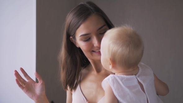 Mother and Baby. Happy Family. Mom With Her Child Smiling and Laughing at Home. alt