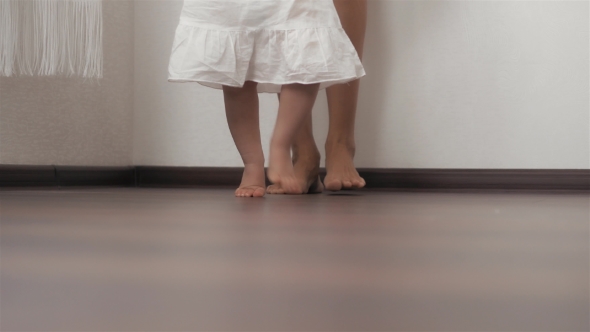 Caucasian Mother Supporting Her Little Baby Practicing Her First Steps