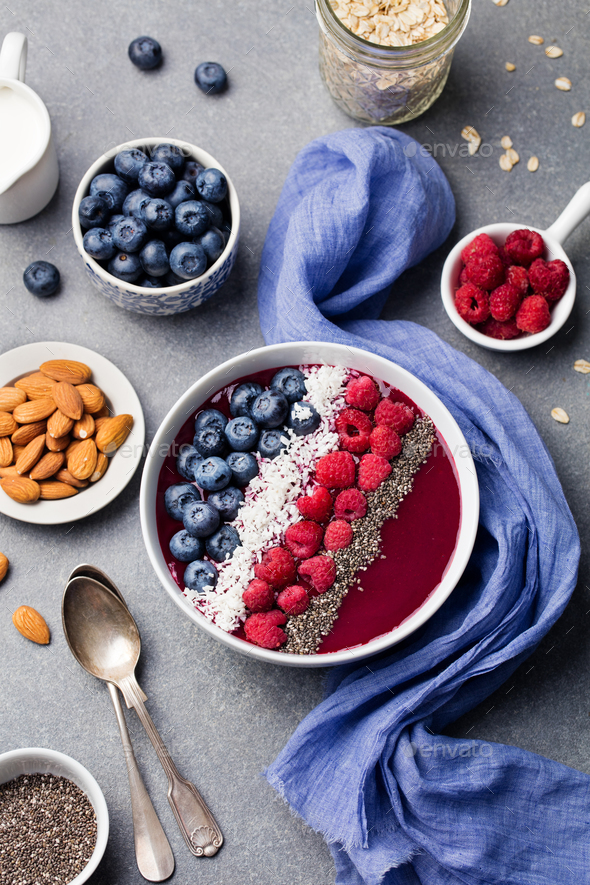 Smoothie bowl raspberry, blueberry, coconut flakes Stock Photo by