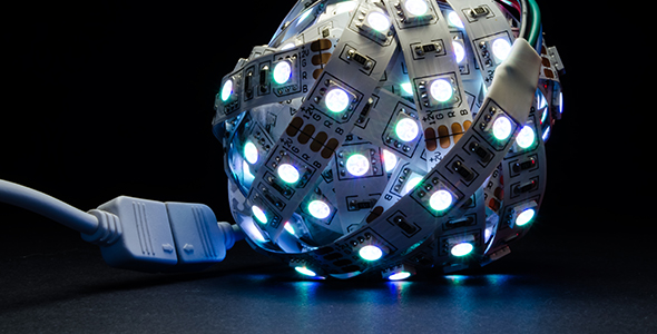 Led Strip Twisted Into a Ball Light of Different Colors on Black Background