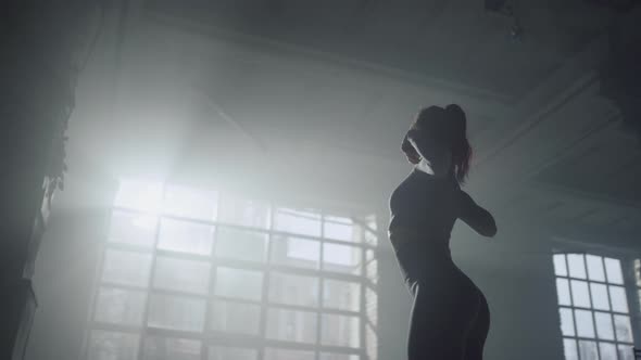 Female Bodybuilder Stretching Shoulder Muscles alt