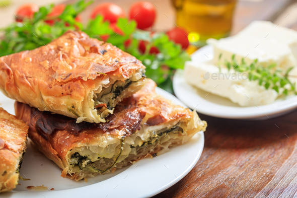 Spinach pie pieces on a table - Stock Photo - Images